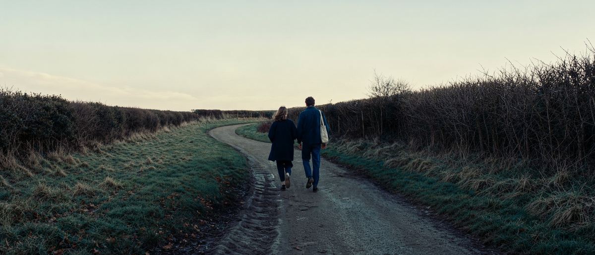 A couple walking a quiet country road at first light